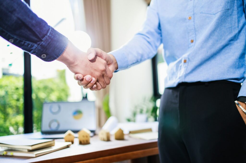 Top 6 Real Estate Investment Strategies for 2024: Expert Insights 4 Real estate agent handshake, deal business. Business partnership meeting and home insurance
